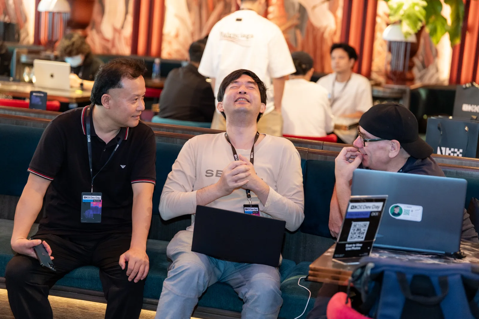Builders in conversation between pitches at OKX Dev Day Singapore